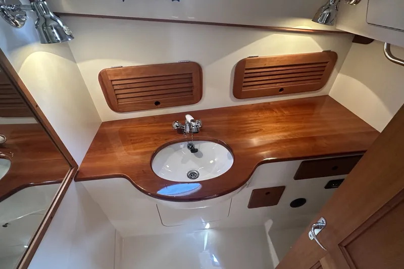 Slide: The Image of Hinckley Picnic Boat 36 EP 2005 bathroom with wooden countertop and sink. - 26