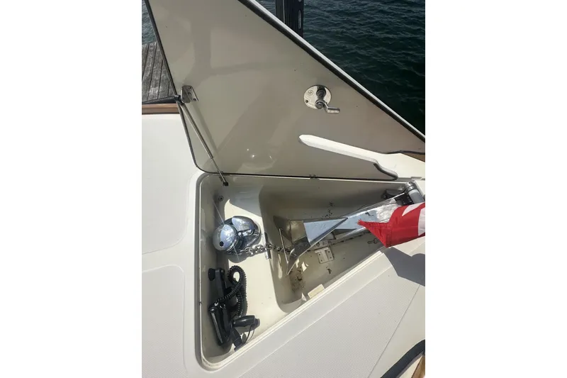 Slide: The Image of Open anchor compartment on 2005 Hinckley Picnic Boat 36 EP, showing anchor and chain. - 33