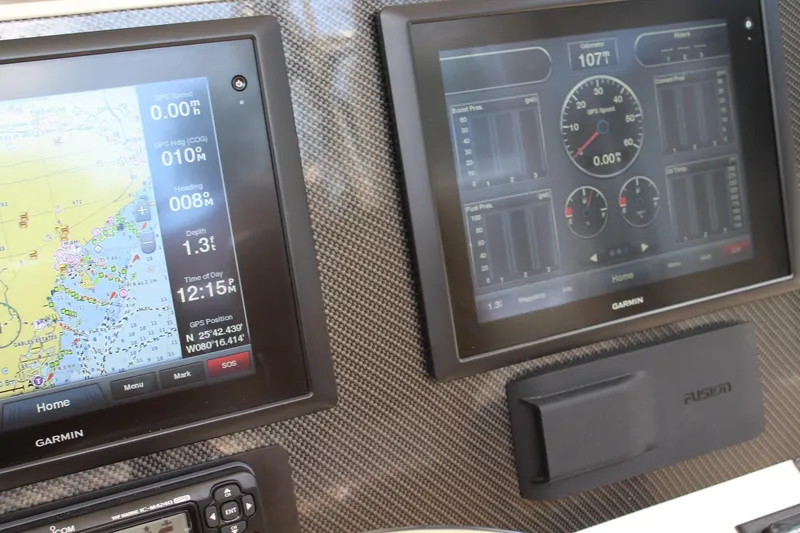 Slide: The Image of Dashboard of a 2008 Contender 38 Express with Garmin navigation displays. - 18