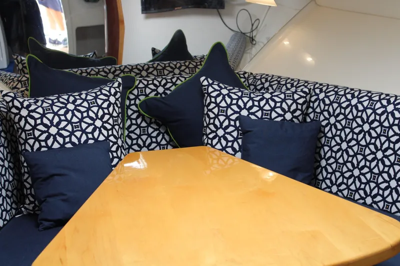 Slide: The Image of Interior of 2008 Contender 38 Express with patterned cushions and wooden table. - 36