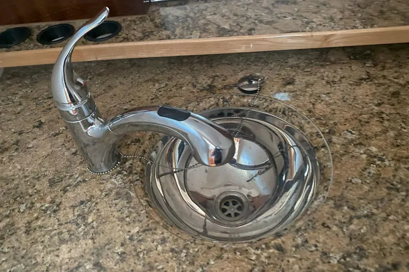 Slide: The Image of Stainless steel sink and faucet on granite countertop in 2008 Contender 38 Express. - 44