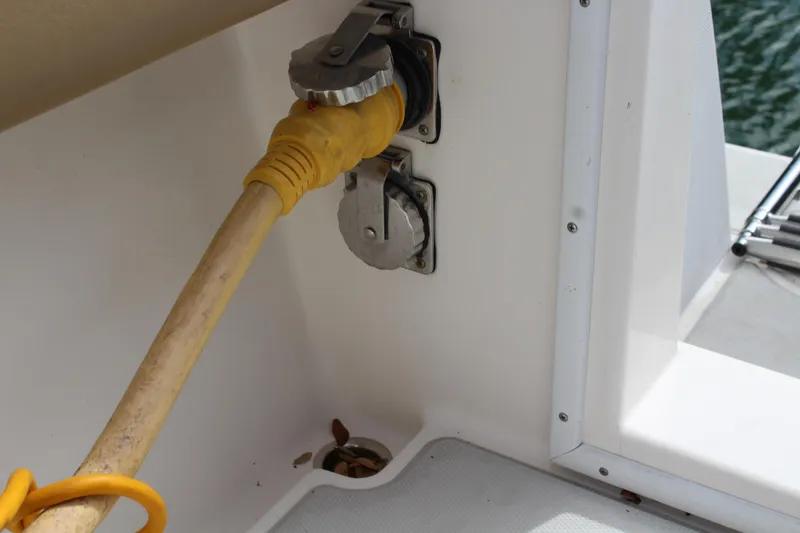Slide: The Image of Power connection on 2008 Contender 38 Express boat, featuring yellow cable and outlet. - 69
