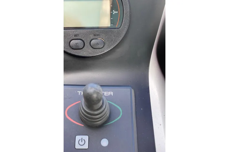 Slide: The Image of Control panel of a 2008 Contender 38 Express boat with joystick and display. - 19