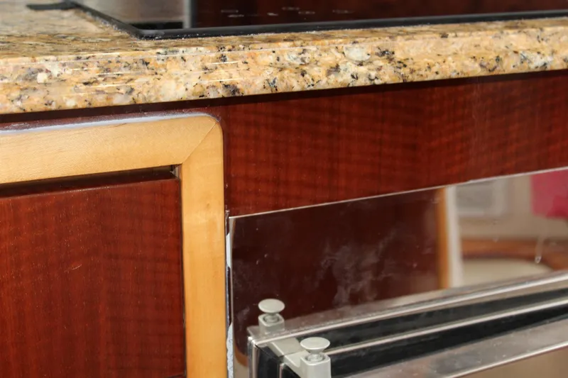 Slide: The Image of Granite countertop and wooden cabinetry detail on a 2008 Contender 38 Express boat. - 48