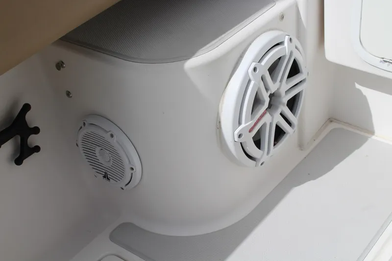 Slide: The Image of 2008 Contender 38 Express boat interior with white speakers and seating area. - 63