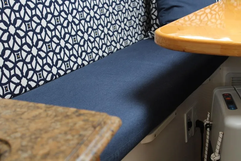 Slide: The Image of 2008 Contender 38 Express interior with patterned upholstery and wooden table. - 38