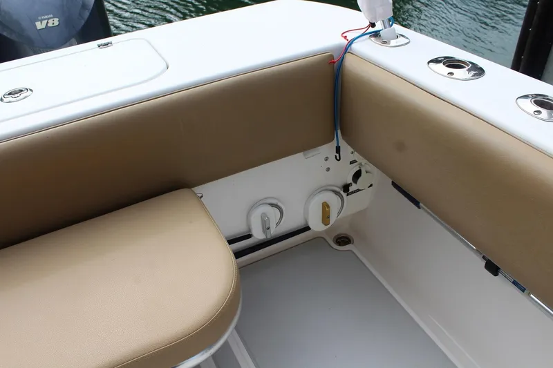 Slide: The Image of 2008 Contender 38 Express boat interior with tan seating and Yamaha V8 engine. - 22