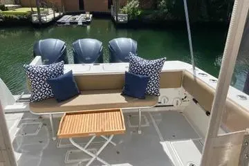 Slide: The Image of 2008 Contender 38 Express boat deck with seating, cushions, and table. - 29