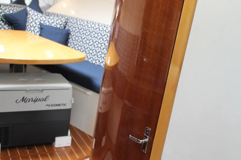 Slide: The Image of Interior of 2008 Contender 38 Express with wooden door, table, and patterned seating. - 50
