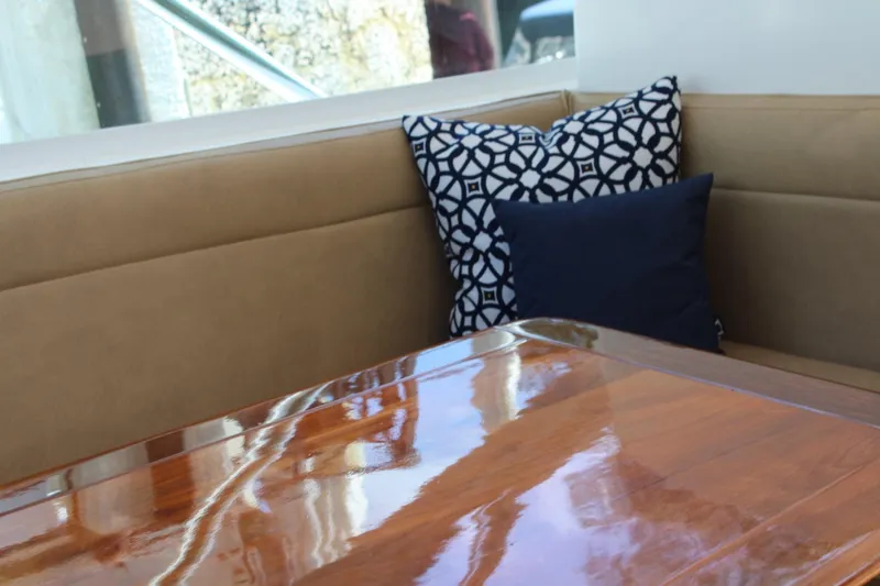 Slide: The Image of Interior of 2008 Contender 38 Express with polished wood table and decorative cushions. - 28