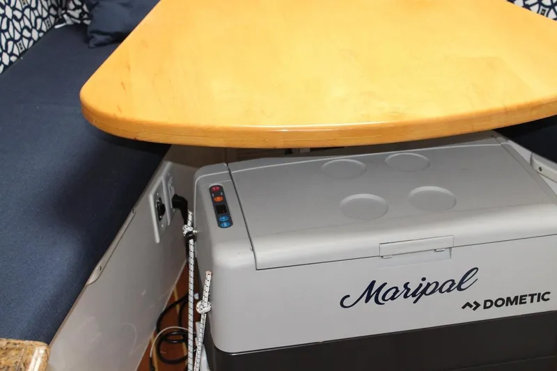Slide: The Image of 2008 Contender 38 Express interior with wooden table and Dometic cooler. - 40