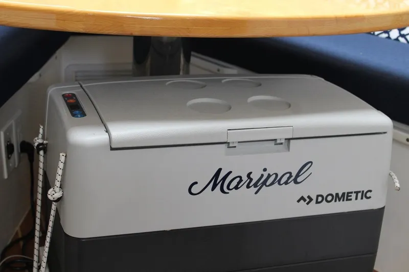 Slide: The Image of Dometic cooler labeled "Maripal" inside 2008 Contender 38 Express boat cabin. - 39