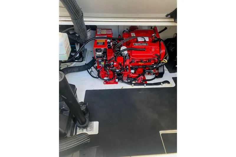 Slide: The Image of Engine compartment of a 2008 Contender 38 Express boat, featuring a red engine. - 56