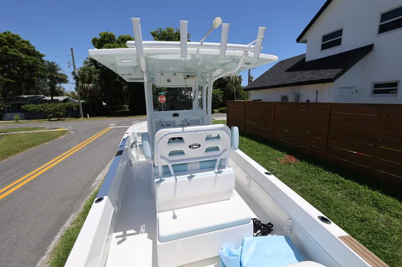 Slide: The Image of 2024 Dusky 278 XFY boat parked on a residential street, showcasing its sleek design. - 8