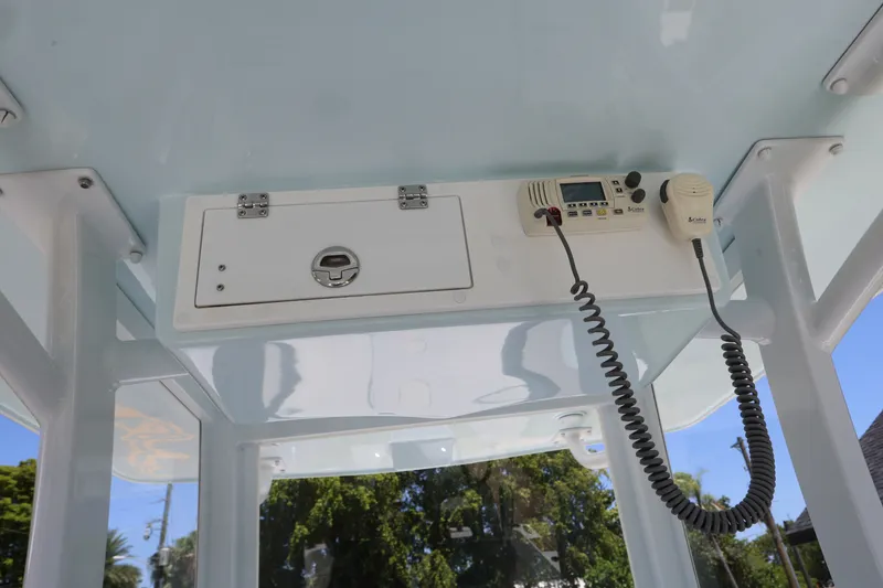 Slide: The Image of 2024 Dusky 278 XFY boat console with radio and storage compartment. - 10