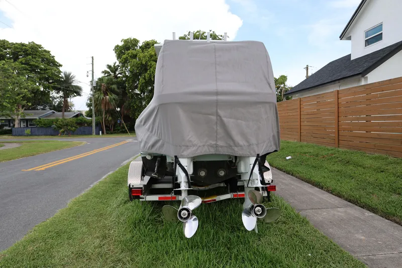 Slide: The Image of Covered 2024 Dusky 278 XFY boat on trailer, parked on suburban street. - 20
