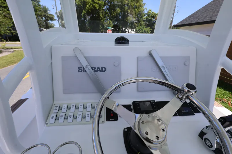 Slide: The Image of Dashboard of 2024 Dusky 278 XFY boat with steering wheel and controls. - 12