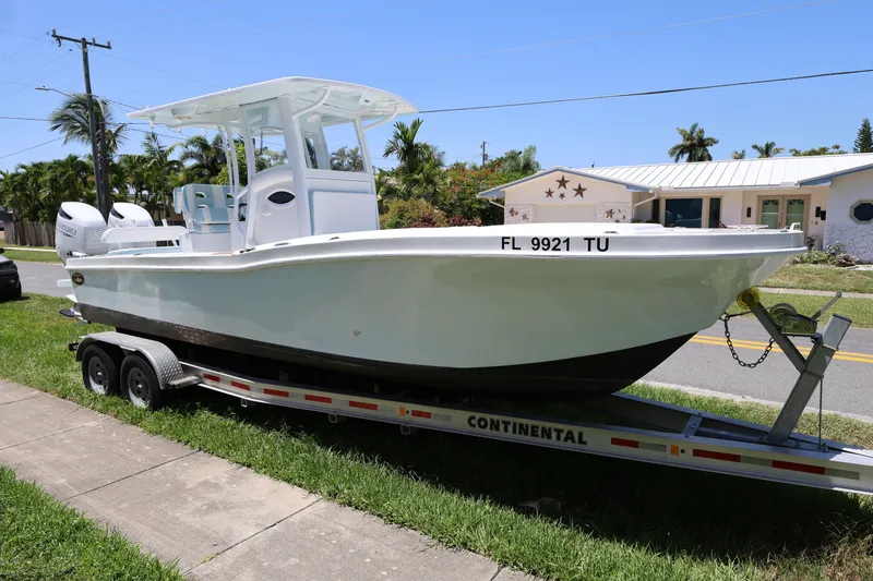 Slide: The Image of 2024 Dusky 278 XFY boat on trailer, parked in residential area. - 7