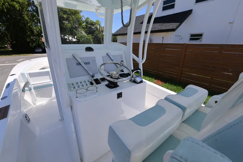 Slide: The Image of 2024 Dusky 278 XFY boat interior with steering console and seating, showcasing modern design. - 9
