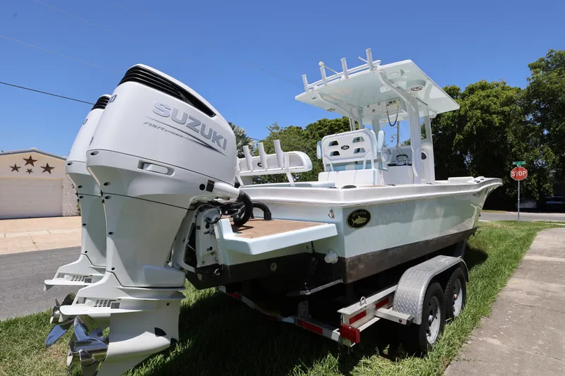 Slide: The Image of 2024 Dusky 278 XFY boat with Suzuki engine on trailer, parked outdoors. - 5