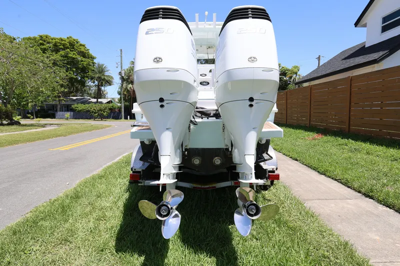 Slide: The Image of 2024 Dusky 278 XFY boat with dual outboard engines on a sunny street. - 4