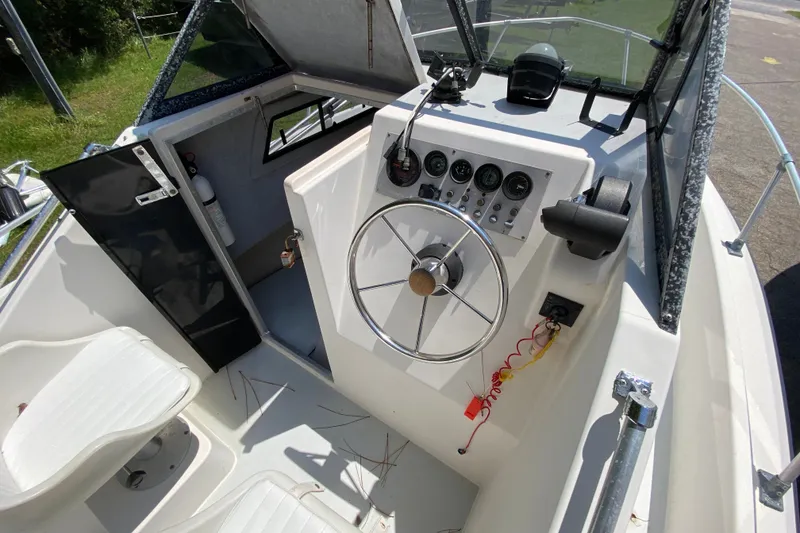 Slide: The Image of Interior of a 1991 Horizon 204 boat showing steering wheel and control panel. - 9