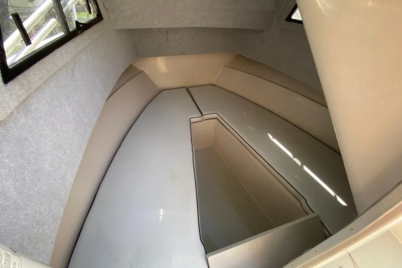 Slide: The Image of Interior cabin of a 1991 Horizon 204 boat, featuring a spacious, clean layout. - 10