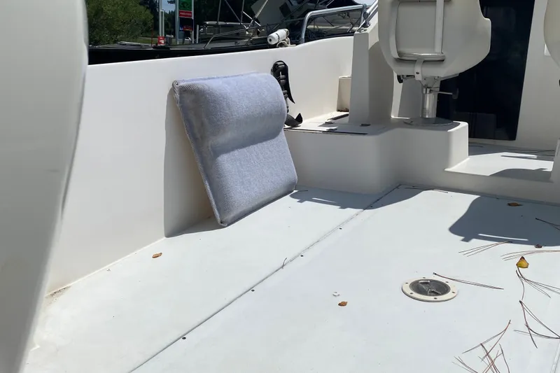 Slide: The Image of Interior of a 1991 Horizon 204 boat, featuring seating and a cushion. - 6