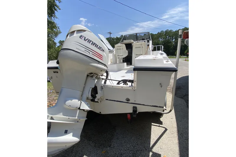 Slide: The Image of 1991 Horizon 204 boat with Evinrude outboard motor, parked on a sunny day. - 4