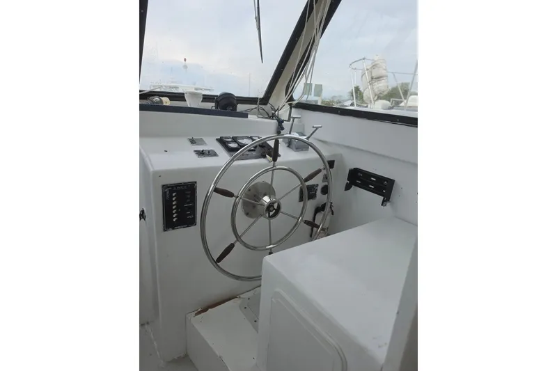 Slide: The Image of 1966 Uniflite Sportfisherman helm with steering wheel and control panel. - 15