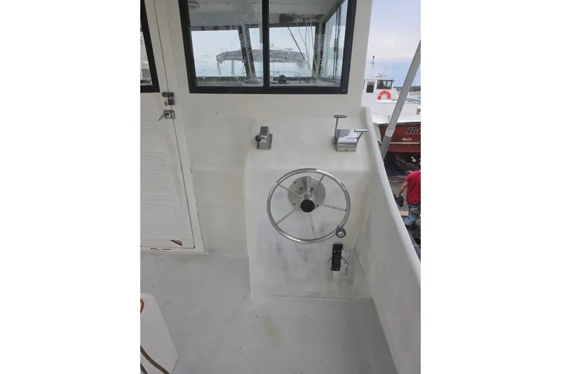 Slide: The Image of 1966 Uniflite Sportfisherman boat helm with steering wheel and controls. - 16