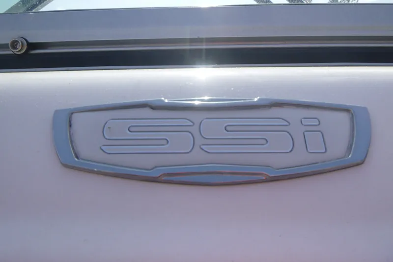 Slide: The Image of 2021 Chaparral 23 SSi emblem on a white surface, showcasing sleek design. - 16