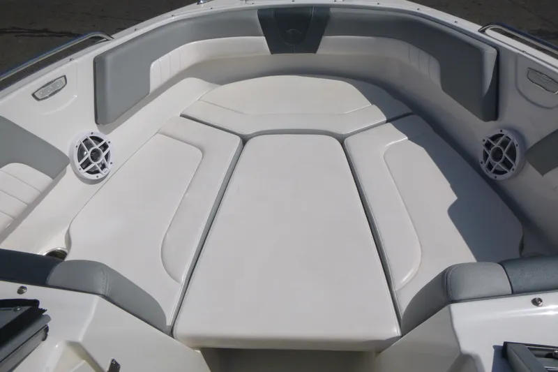 Slide: The Image of 2021 Chaparral 23 SSi boat interior with cushioned seating and built-in speakers. - 7