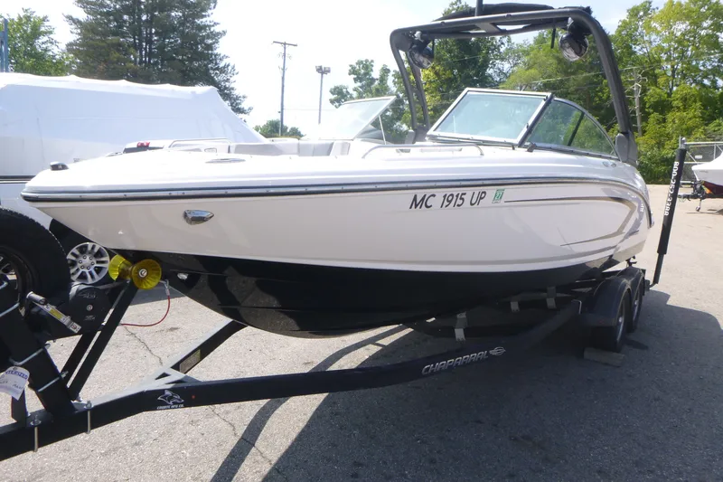 Slide: The Image of 2021 Chaparral 23 SSi boat on trailer, parked outdoors. - 2