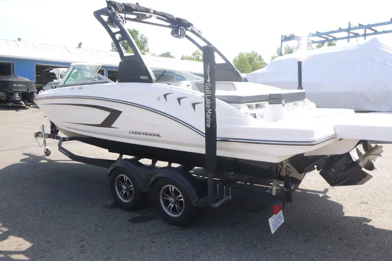 Slide: The Image of 2021 Chaparral 23 SSi boat on trailer, displayed outdoors at a marina. - 3