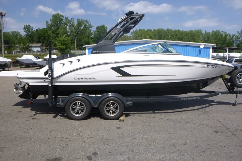 Slide: The Image of 2021 Chaparral 23 SSi boat on trailer, parked outdoors on a sunny day. - 4