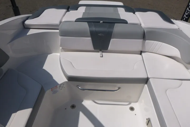 Slide: The Image of 2021 Chaparral 23 SSi boat interior with white and gray seating arrangement. - 11