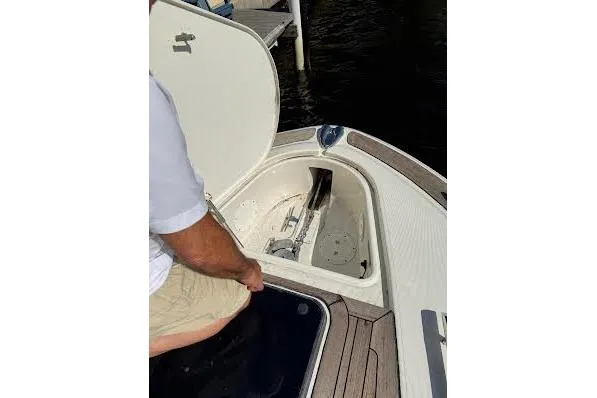 Slide: The Image of 2006 Chris Craft Corsair Heritage boat anchor compartment open on deck. - 22