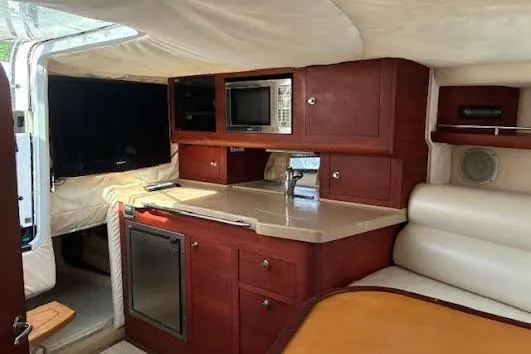 Slide: The Image of 2006 Chris Craft Corsair Heritage cabin interior with kitchenette and seating area. - 31