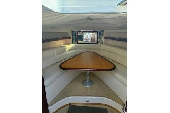 Slide: The Image of Interior of 2006 Chris Craft Corsair Heritage boat with elegant seating and wooden table. - 28