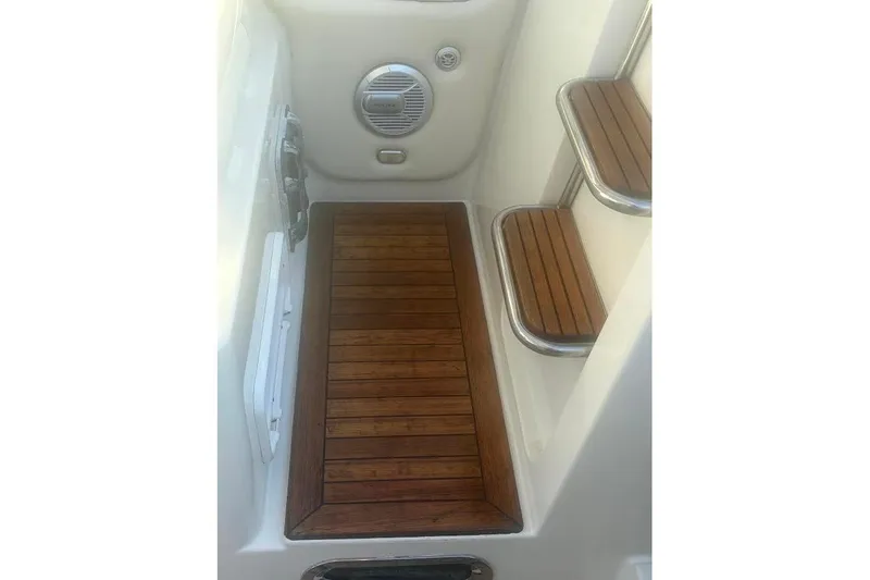 Slide: The Image of 2006 Chris-Craft Corsair 33 boat interior with wooden steps and flooring. - 40