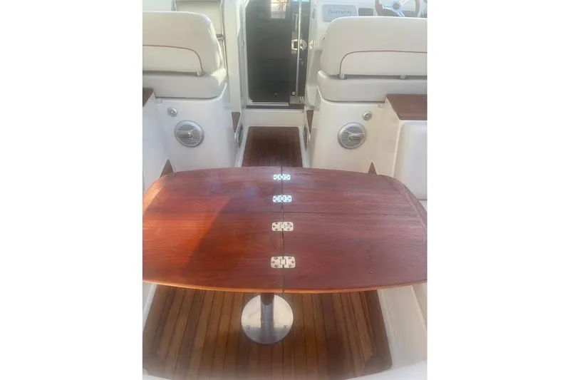 Slide: The Image of Interior of 2006 Chris-Craft Corsair 33 with wooden table and seating. - 42