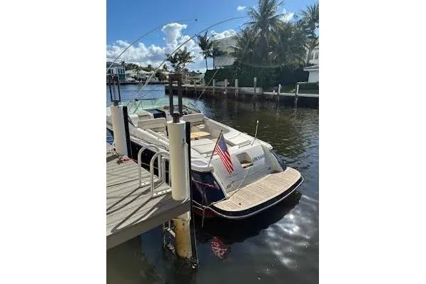 Slide: The Image of 2006 Chris Craft Corsair Heritage boat docked by a sunny waterfront. - 38