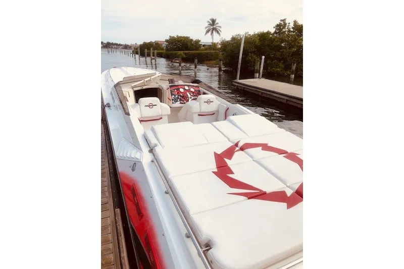 Slide: The Image of 2006 Fountain 42 Executioner speedboat docked by a serene waterfront. - 3