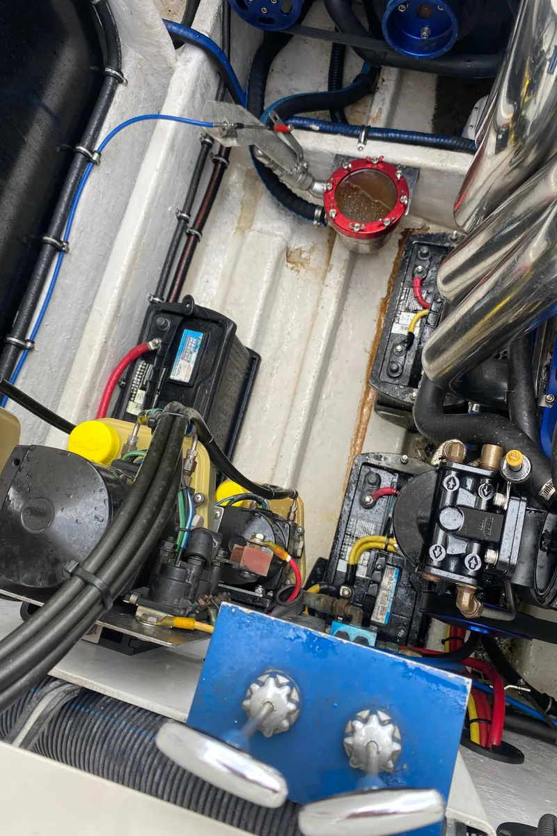 Slide: The Image of Engine compartment of a 2006 Fountain 42 Executioner boat, showcasing wiring and mechanical components. - 18
