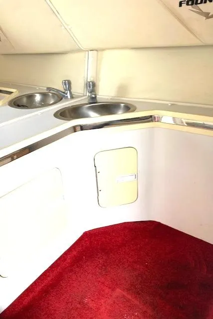 Slide: The Image of Interior of 2006 Fountain 42 Executioner boat with red carpet and dual sinks. - 12