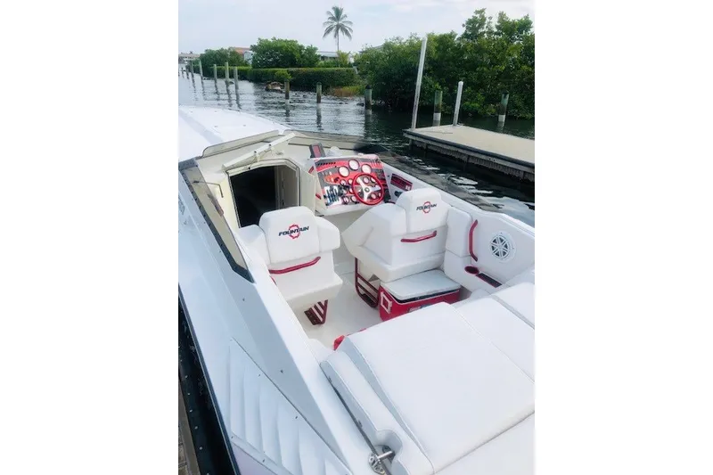 Slide: The Image of 2006 Fountain 42 Executioner boat interior with white and red seating, dockside view. - 27