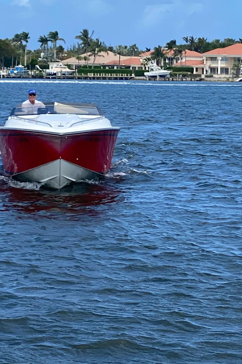 Slide: The Image of 2006 Fountain 42 Executioner speedboat cruising on a sunny day near waterfront homes. - 21