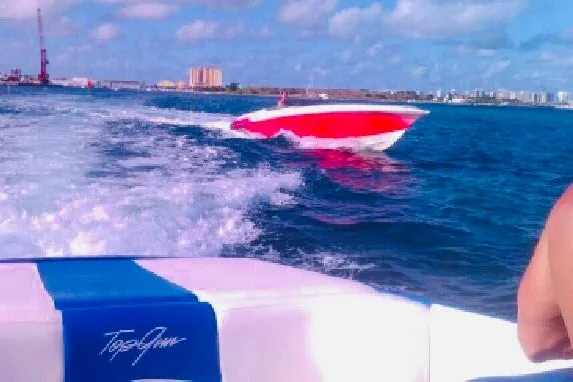 Slide: The Image of 2006 Fountain 42 Executioner speedboat cruising on open water under a clear blue sky. - 5