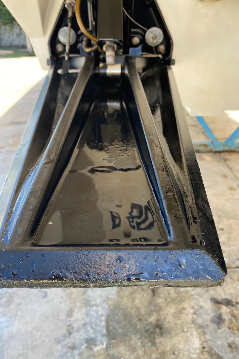 Slide: The Image of Close-up of a 2006 Fountain 42 Executioner boat component, showcasing sleek black metalwork. - 25